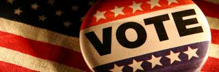 Button with the word 'Vote' on top of an American Flag