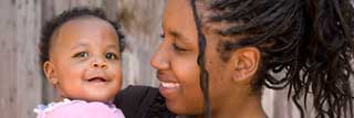 A smiling mother holds her child