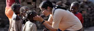 A woman interacting with African children
