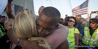 Two protestors hugging