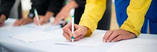 Several people signing a petition
