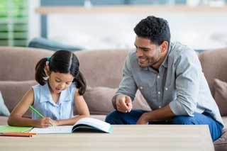 A father helping his daughter with her homework