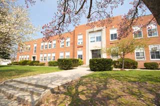 The front of a school building in spring