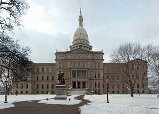The outside of the Michigan State Capital building on a snowy winter day
