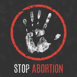 A worn illustration of a white hand inside a red circle with the words Stop Abortion underneath.