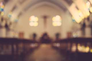 The interior of a Catholic church, blurred for artistic effect.