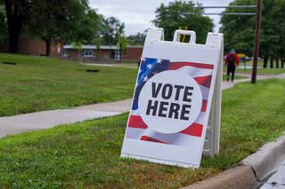 A “Vote Here” displayed outside of a polling location on Primary Election Day in 2024