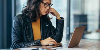 A young professional attending a webinar on her laptop
