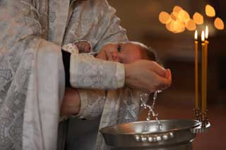 A young child being baptized.
