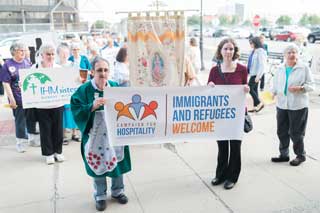 Members of Strangers No Longer — a multi-parish Catholic advocacy group that raises awareness and aid for immigrants in the Detroit area — held signs and banners during an event held at Most Holy Trinity Parish in Detroit that included a Mass where Catholics prayed for unity and a solution to the current crisis at the U.S.-Mexico border.