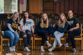 Jeanne Damer, (far left) Pat Damer, (far right) and their daughters inside of Christ the Redeemer Catholic Community in Lake Orion, where Pat and Jeanne serve on the parish's peace and justice committee to promote awareness of gun violence. Photo credit Valaurian Waller.