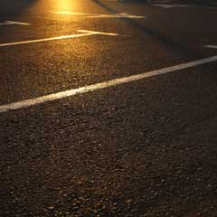 Close-up of a parking lot at sunset
