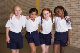 Four children dressed in school uniforms
