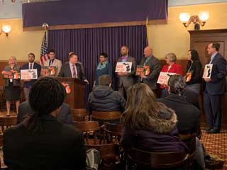 Attendees of a press conference at the Michigan Capitol with a bipartisan group of State Senators who support Raise the Age legislation