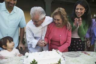 A happy family cuts a cake