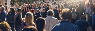 A crowd of people walking down the street