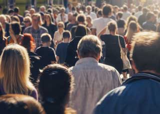 A crowd of people walking down the street