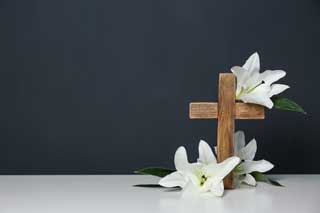 A crucifix and white lillies