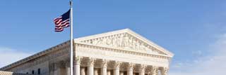 The flag of the United States flying over The Supreme Court building in Washington, DC