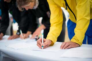 Several people signing a petition