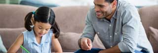 A father helping his daughter with her homework