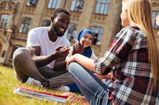 A group of three young people discussing politics while sitting outside