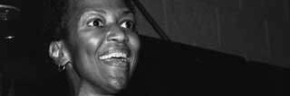 Sister Thea Bowman, on stage and smiling at an event held at Walsh University on September 18, 1989