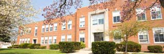The front of a school building in spring