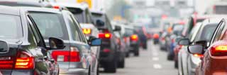 A line of cars stopped at a traffic light