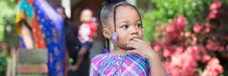 A grandmother (background) watches her granddaughter.