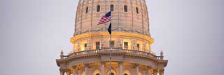 The dome of the Michigan State Capital building seen from the outside at dusk