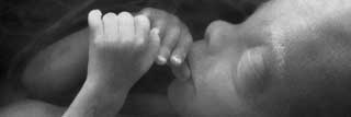 Black and white image of a baby in its mother's womb