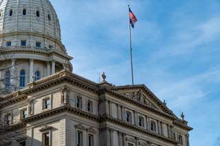 The Michigan State Capitol building on a sunny day.