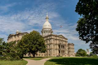 The Michigan State Capitol building on a sunny day.