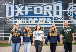 From left to right: Jeanne Damer and her daughters Sophia, an Oxford High School senior; Isabella, a Michigan State University junior; Mia, an Oxford freshman; and her husband Pat in front of Oxford High School. 