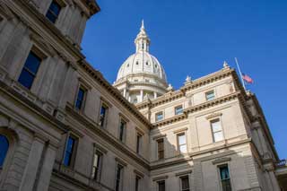 The Michigan State Capitol building on a sunny day.