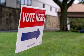 A “Vote Here” sign displayed outside of a polling location on Primary Election Day in 2024