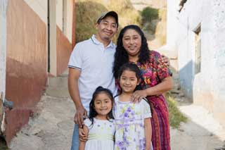 A Guatemalan family in the alley of their neighborhood