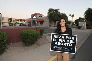 Mayra Rodriguez outside of Planned Parenthood holding a 40 Days for Life sign