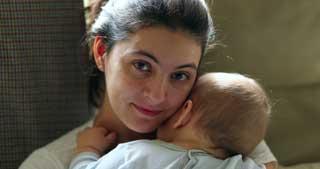 A mother cradling her child