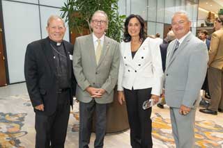 Bishop Robert Gruss of the Diocese of Saginaw, with (from left) Rep. Tim Kelly (R-Saginaw), Rep. Angela Witwer (D-Lansing), and MCC policy advocate Paul Stankewitz.
