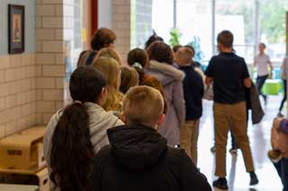 Catholic school children walking down a hallway