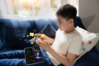 A young boy, sitting on the sofa, interacting with an AI chatbot